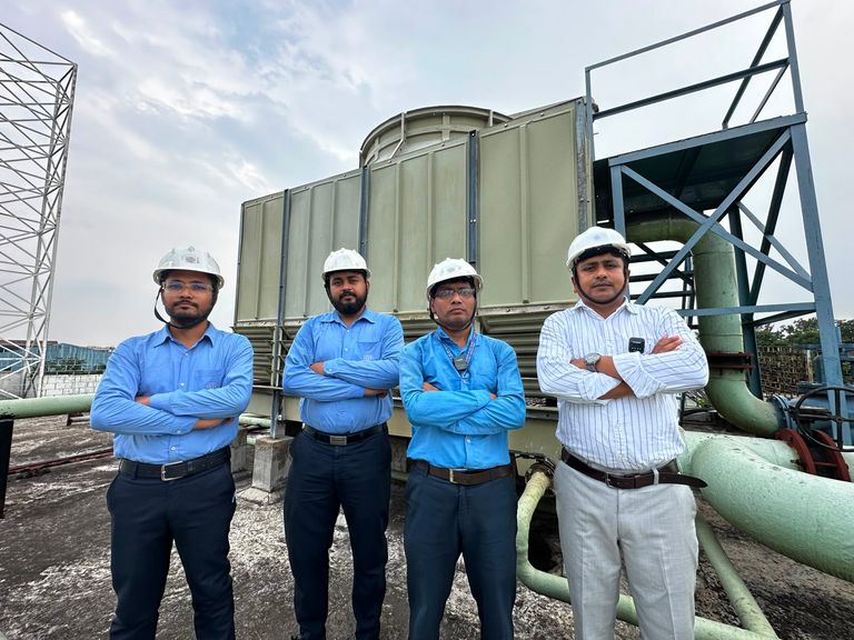 Site team at the cooling tower — utility infrastructure O&M